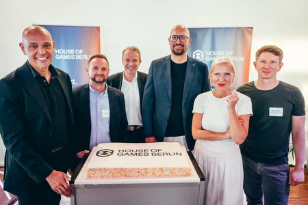 People standing around a decorated cake