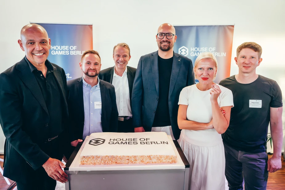 People standing around a decorated cake