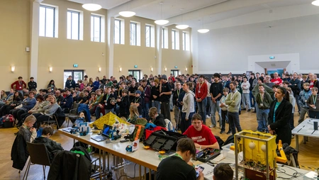 Saal voller Menschen, die in Richtung Bühne schauen