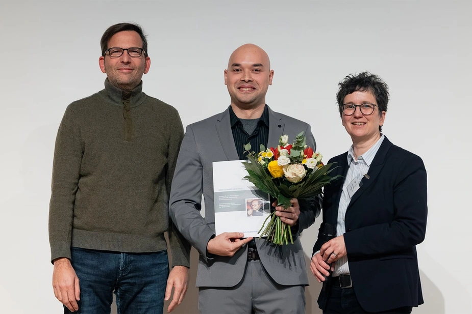 Awardee with certificate and flowers